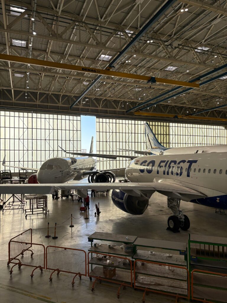 Aircraft undergoing maintenance inside hangar with aviation AOG logistics support