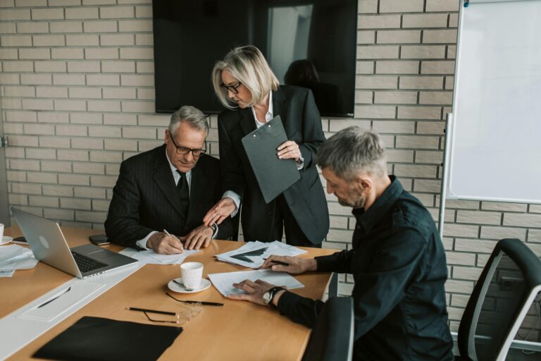 Business professionals signing legal documents with secure courier delivery support