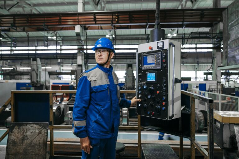 Industrial engineer operating manufacturing equipment supporting same-day engineering courier services across the UK